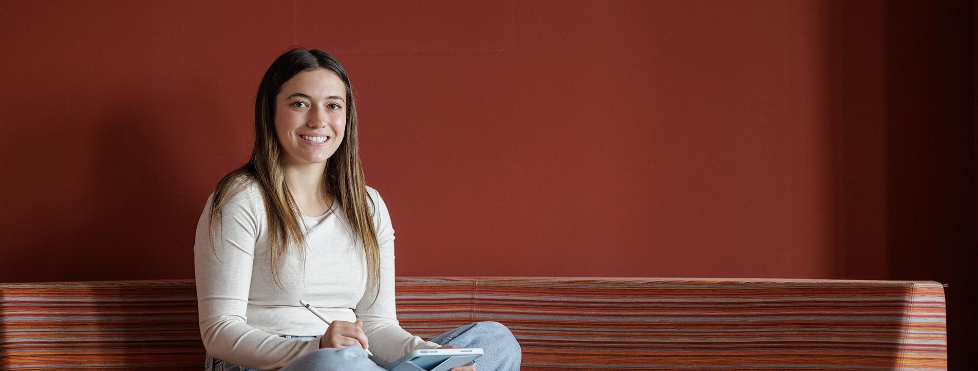 female student studying in lounge